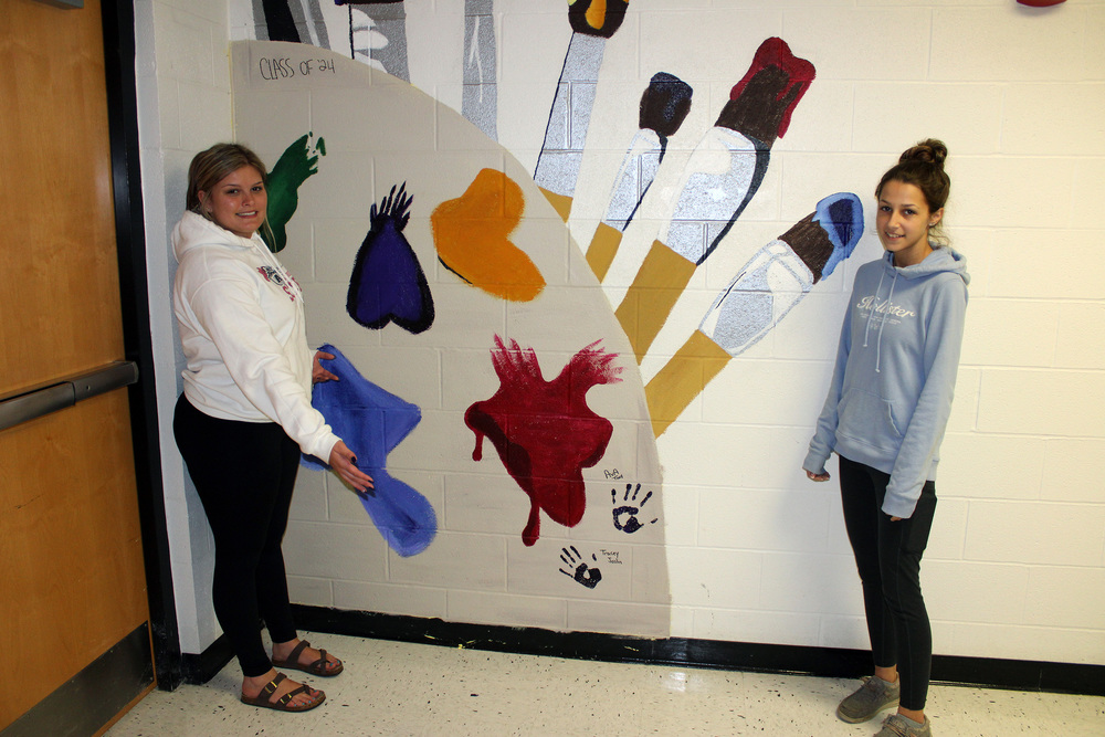 ​Advanced Art students Tracey Joslin and Ava Tracy had a great time creating a new mural for the art hallway.  Ava and Tracey researched mural ideas for one of their quarter four projects and decided on an artist palette and brushes.  These ladies did an excellent job with this project and have already come up with a few more mural ideas for the 2023-24 school year.  Great work Ava and Tracey.''