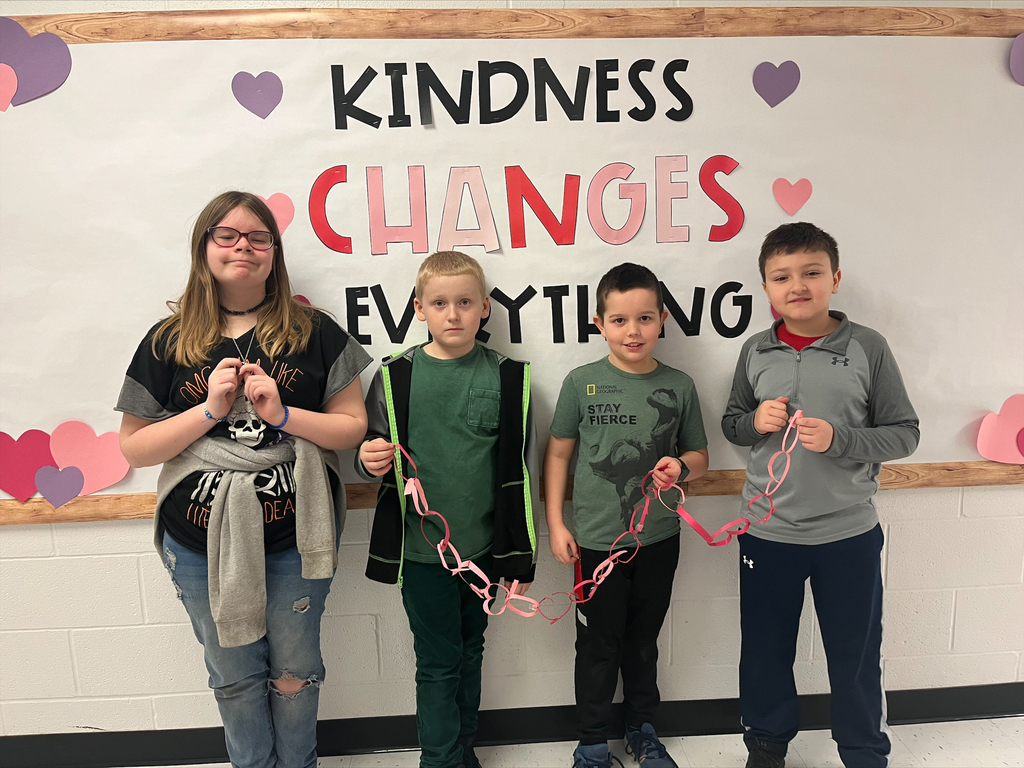 Students in front of Kindness changes everything poster